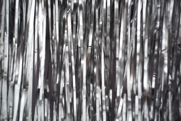 Blurred festive background of shiny silver Christmas paper