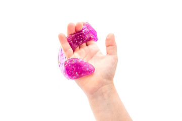 Modern toy called slime. Child playing transparent purple slime. Hands holding a mucus isolated on a white background. Selective focus.	