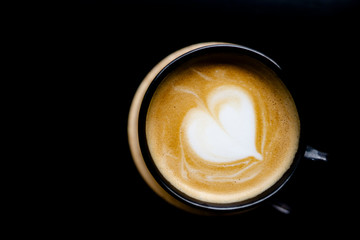 top view on aromatic hot coffee latte with black background space