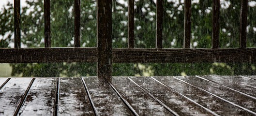 Pouring rain splashing on a deck.