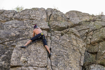 Man climber climbing to the top of the rock.
