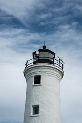 Fototapeta na wymiar White Lighthouse against a Blue Sky