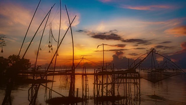 Timelapse 4K of beautiful sunrise with fishing trap in pak pra village, Phatthalung Thailand