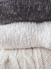 Fototapeta na wymiar Pile of chunky winter sweaters.