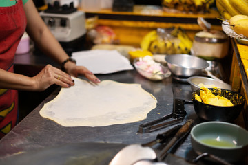 Fototapeta premium Roti Making, roti thresh flour by roti maker with oil.Thailand Street Food and Desserts. crispy pancake in Thailand