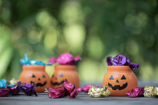 Halloween jack-o-lantern pail with spilling candy
