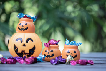 Halloween jack-o-lantern pail with spilling candy