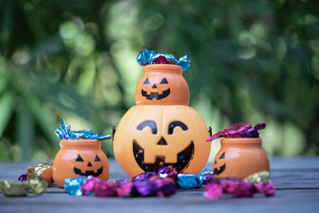 Fototapeta premium Halloween jack-o-lantern pail with spilling candy