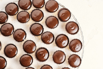 Chocolate ganache candy with almonds. Pouring chocolate, homemade dessert.