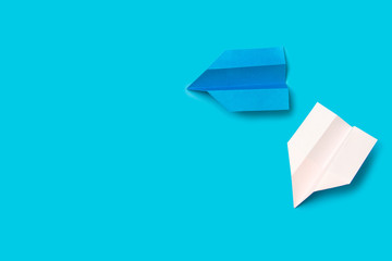 Origami paper airplane on blue background