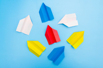 Origami paper airplane on blue background