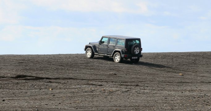 VIK, ICELAND - MAY 03, 2018: Jeep Wrangler Unlimited Sport four wheel drive vehicle being used on terrain on a black sand beach in Iceland
