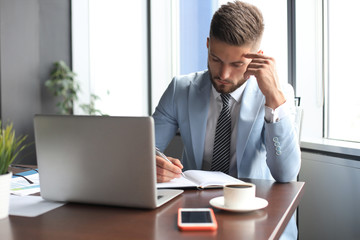 Modern businessman thinking about something while sitting in the office