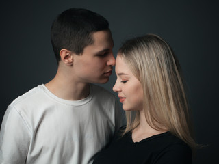 Young beautiful couple in love posing in studio.