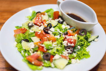 Authentic greek salad plate close up in Italian restaurant