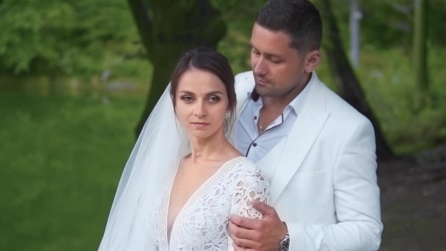 Beautiful moment of groom kissing his bride with love and affection, closeup