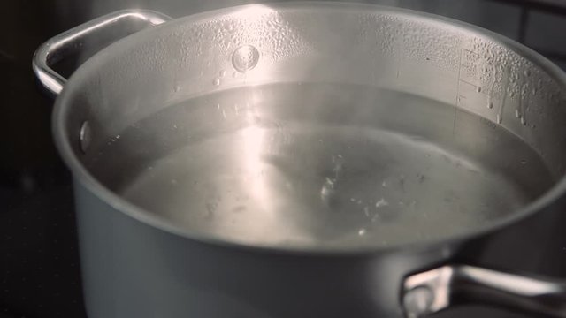 noodles in pot filled with boiling hot water into the sink
