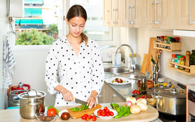 Housewife cooking vegetable salad