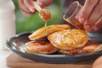Pancakes served honey on table, healthy breakfast for everyday. Clean food good taste for advertising ideas concept. 