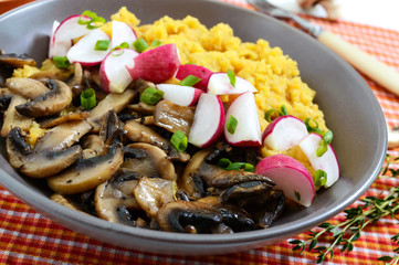 Lentil porridge with mushrooms, radish in a bowl on a white background. Dietary, lean menu. Vegetarian dish.