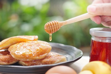 Pancakes served honey on table, healthy breakfast for everyday. Clean food good taste for advertising ideas concept. 