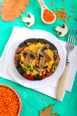 Lentil porridge with mushrooms in a pumpkin pot. Dietary, lean menu. Vegetarian dish.