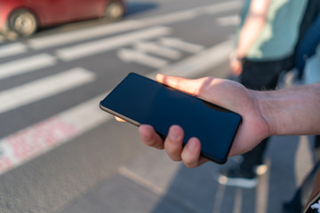 guy holds smartphone in his hands, new frameless