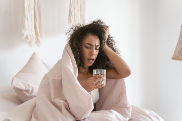 Emotional brunette female person looking at glass of water