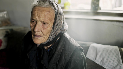 Old Grandma tells the story to the camera while sitting in her room