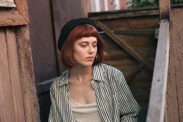 Fashionable young woman sitting on the porch.