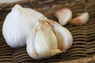 Close up of garlic and garlic cloves on wicker