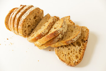 fresh baked slices of wheat bread top view on white background