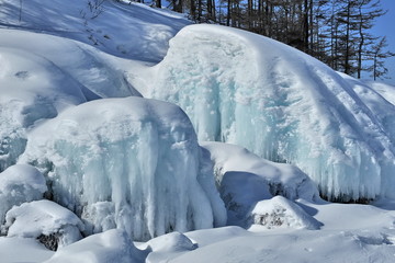 Winter on Lake Baikal. The huge blocks of stone were frozen as a result of the freezing of the washing waves.