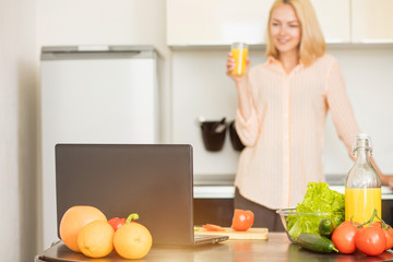 Woman using laptop in the kitchen