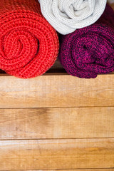 Obraz na płótnie Canvas Knitted scarves on wooden background