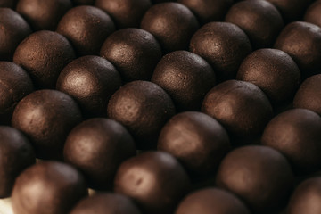 Round chocolates candy. Dark background, luxury dessert, dark chocolate, handmade.