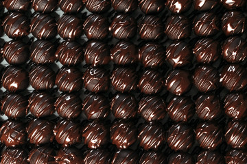 Round chocolates candy. Dark background, luxury dessert, dark chocolate, handmade.