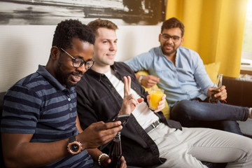 Male friends watching sports on tv at home