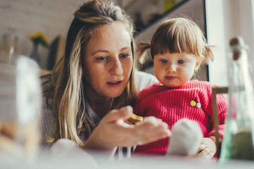 Happy family in the kitchen. Mother and daughter are preparing the christmas cookies.
