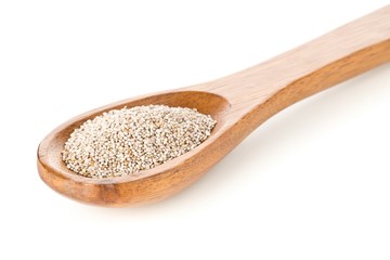 Fototapeta na wymiar White whole, organic chia seeds heap in brown wooden spoon over white background