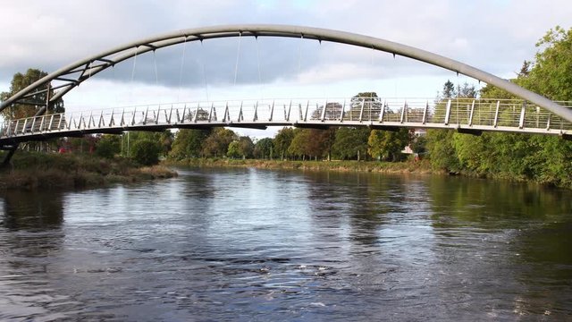 4K video of River Nith and Kirkpatrick Macmillan Pedestrian Bridge in Dumfries in Scotland. The River Nith is a river in south-west Scotland. Water flowing full hd video.