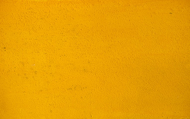 Yellow concrete stucco wall - background or texture