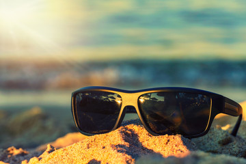 Sunglasses in the sand on a sandy beach