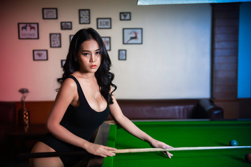 Portrait of asian sexy woman wear black one piece at snooker club,Beautiful Thailand people pose...