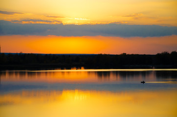 Fototapeta na wymiar orange sunset on a blue lake
