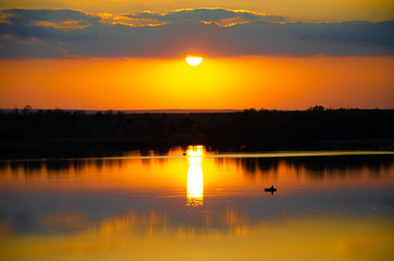 orange sunset on a blue lake