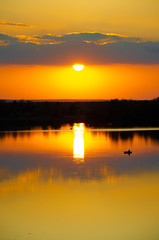 orange sunset on a blue lake