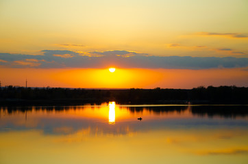 Fototapeta premium orange sunset on a blue lake