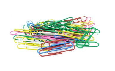 Colorful Paper clips on white paper background. Decorative paper clips in pink, red, green, red and blue colors