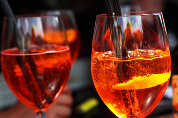 Aperol Spritz Cocktail Alcoholic beverage based on bar counter with ice cubes and oranges.Closeup...